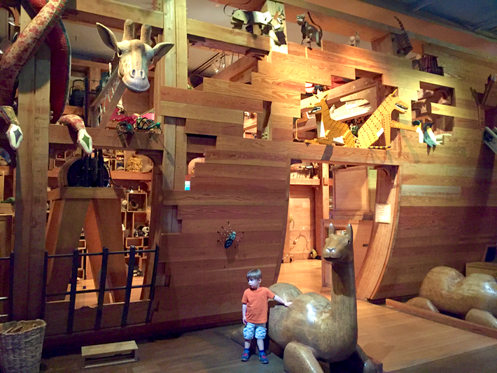 Noah's ark, three stories tall, animals' heads poking out