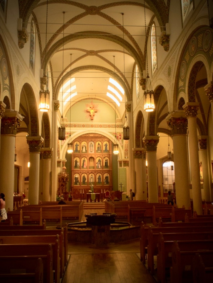 Looking down the nave of a cathedral towards the choir, filled with icons