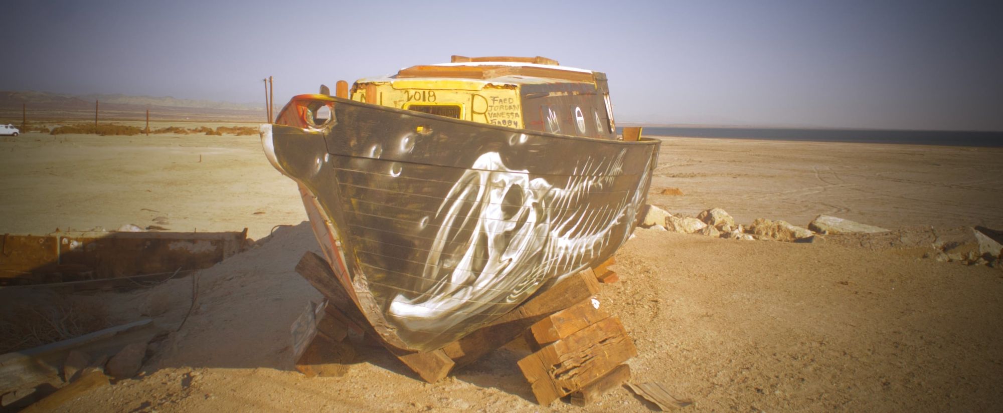 A sailboat up on chocks in the middle of the desert, 200 yards from water