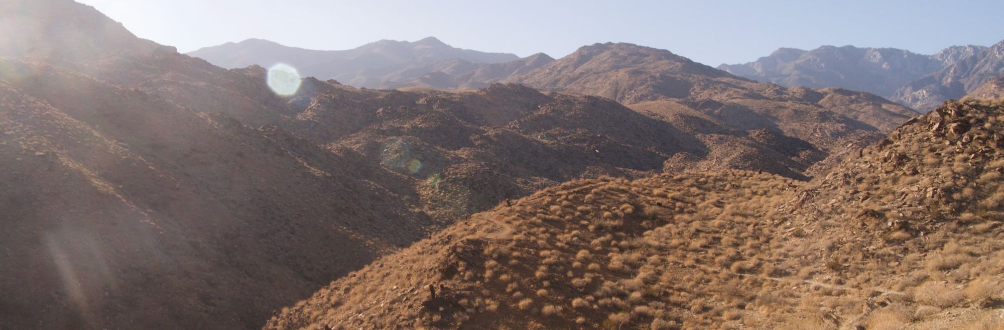 Dry, brown, scrub-covered rolling hills as far as the eye can see