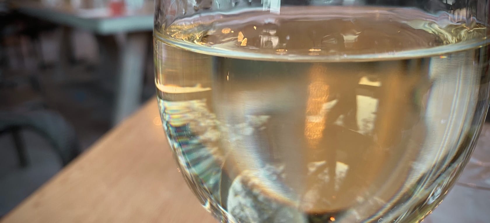 A closeup on a glass of white wine