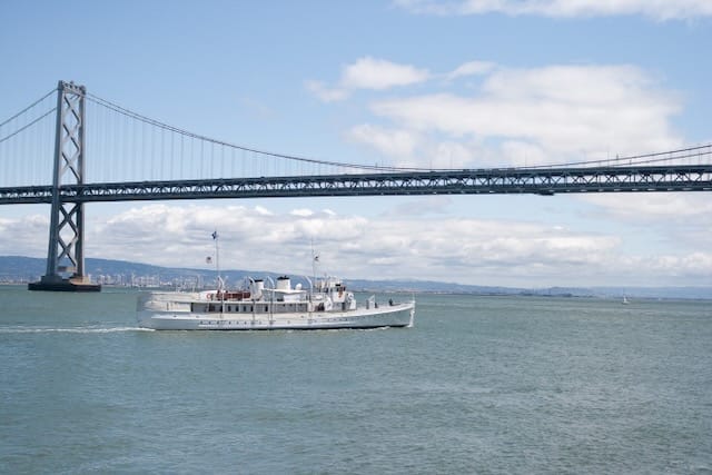 A tour boat under the Bay Bridge